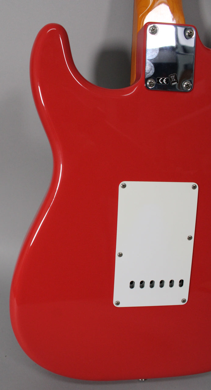 The back of a glossy Fiesta Red Stratocaster, showing the white tremolo cover, chrome neck plate, and a hint of the neck heel.