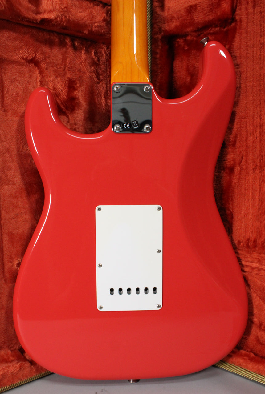 Full rear view of a glossy Fiesta Red Stratocaster body with a white tremolo cover, a light wood neck, and a black neck plate.