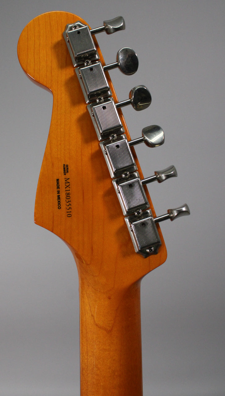 The back of a light brown maple headstock and neck, with six chrome vintage-style tuners on the right.