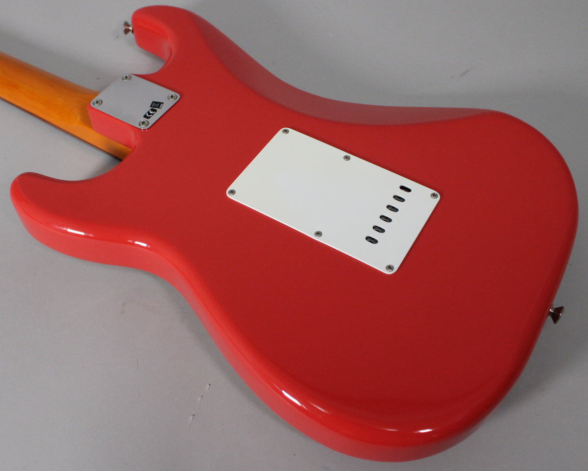 The back of a glossy red Stratocaster, angled from the neck, shows a white tremolo cover and a chrome neck plate.