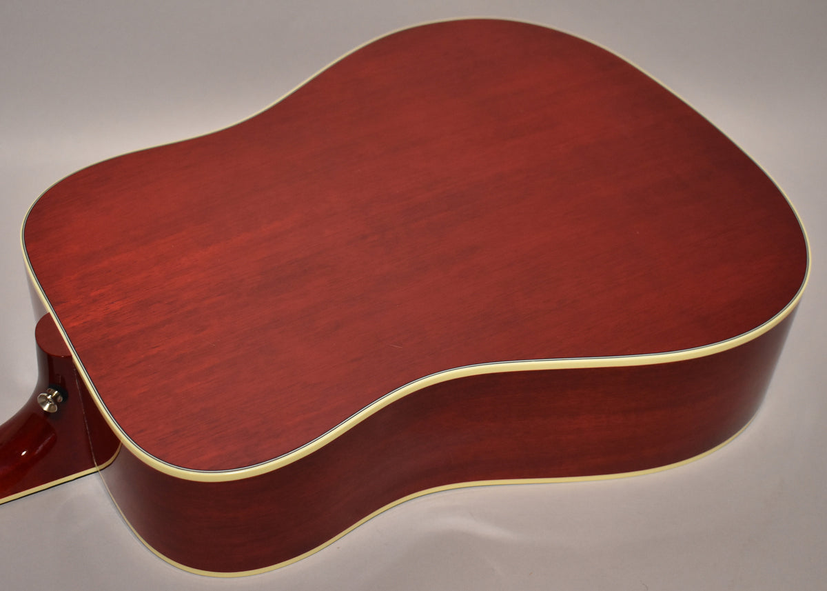 The back of the cherry sunburst acoustic guitar, showing the deep red finish, cream binding, and a visible endpin jack.