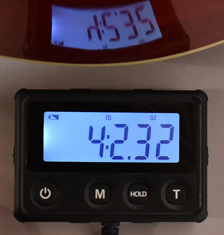 Close-up of a digital scale displaying "4:2.32 lb oz", with a reflection of "4535" visible above.