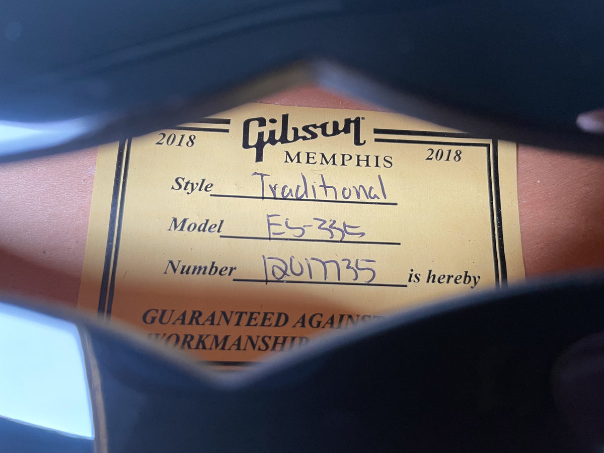 Close-up of the guitar's interior label, showing "2018," "Traditional," "ES-335," and serial number "1201735" handwritten on it.