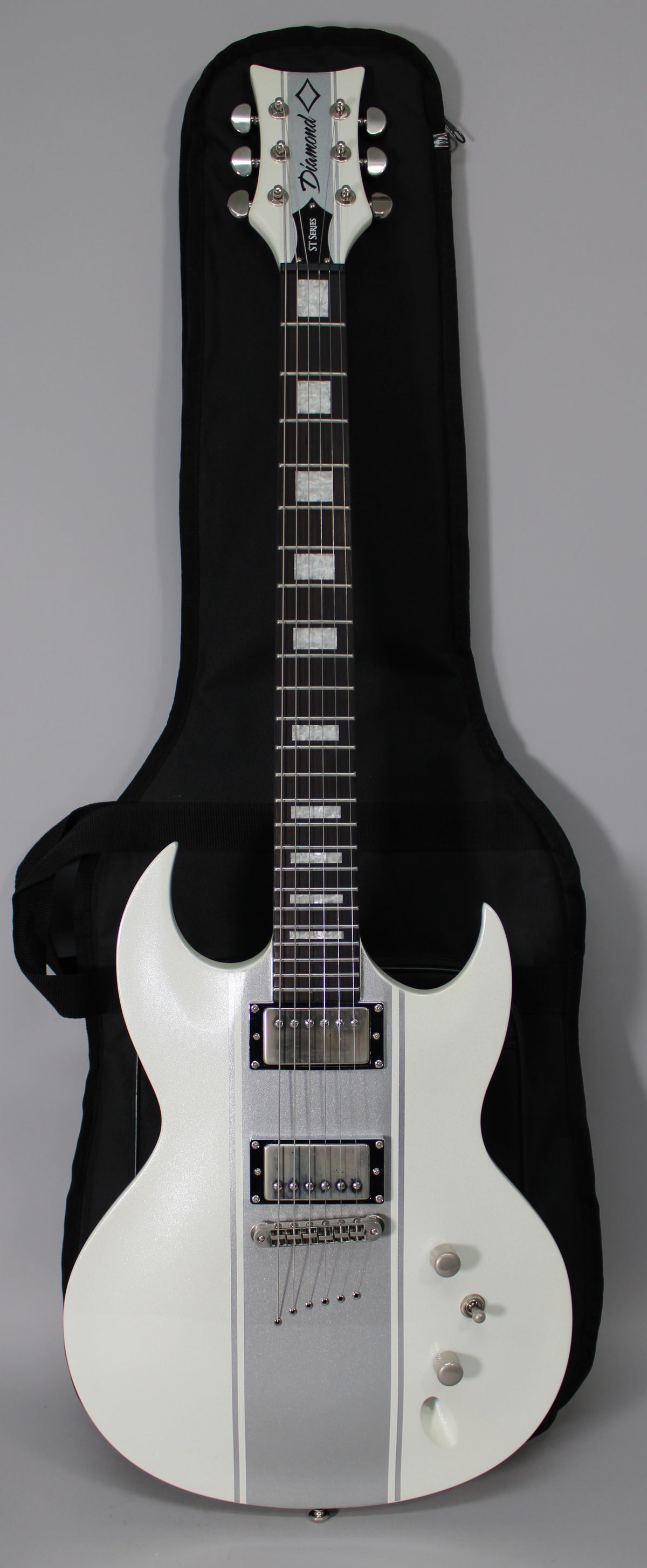 Full-length view of a white electric guitar with silver racing stripes, two humbuckers, and a tune-o-matic bridge, in a black gig bag.