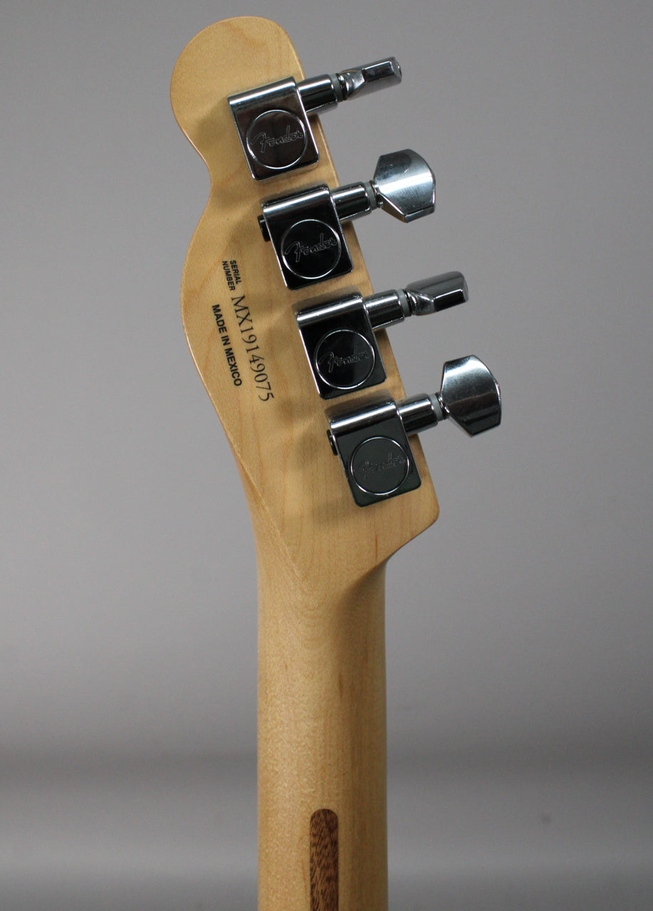 The back of the guitar's headstock and upper neck, showing four chrome tuners and a dark wood skunk stripe on the maple neck.