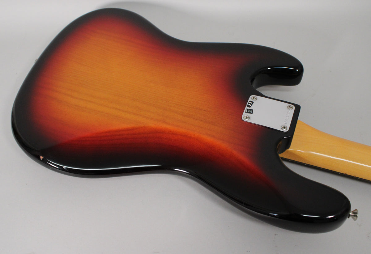 The back of the 3-color sunburst bass body, showing the neck plate and a small chip on the lower bout.