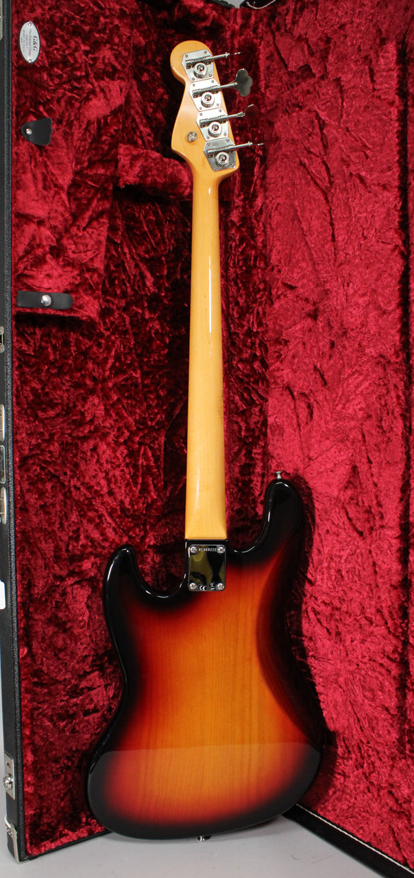 The bass is shown from behind, in its red velvet-lined case, with a glossy 3-color sunburst body and light-colored neck.