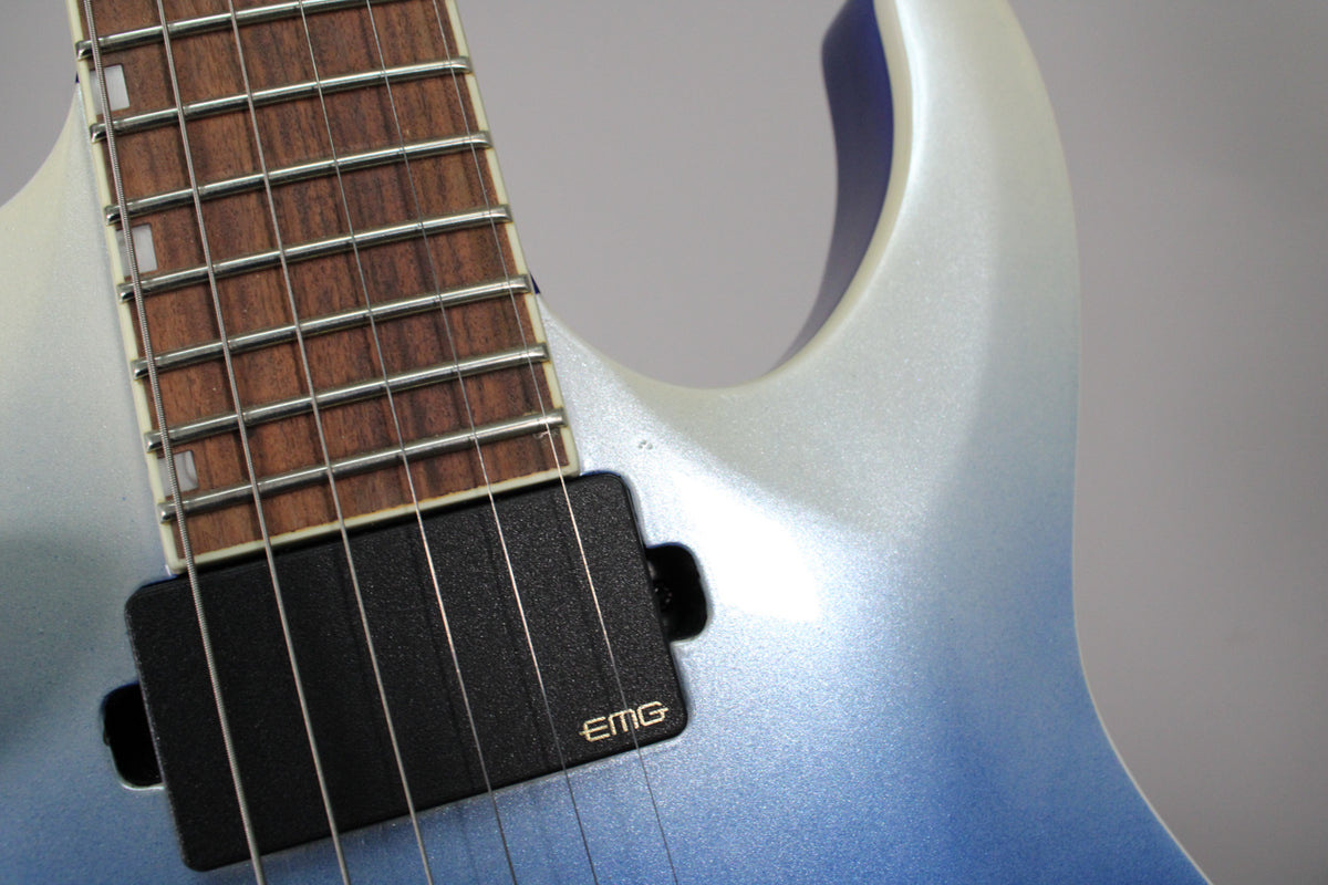 Close-up of the guitar's upper body, showing the blue pearl fade finish, dark fretboard with rectangular inlays, and an EMG neck pickup.