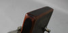 The guitar's dark brown headstock, angled from the left, shows a worn matte finish and a silver tuning peg with a string.