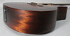 Close-up of the dark brown satin-finish body, showing the endpin jack and a small scratch on the upper bout.