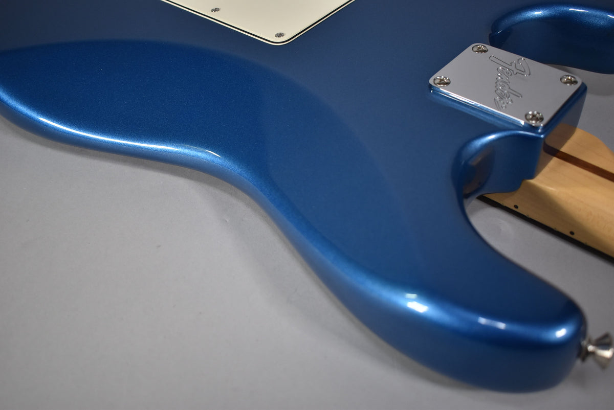 Close-up of the Stratocaster's lower body in satin Lake Placid blue, showing the neck plate and strap button.