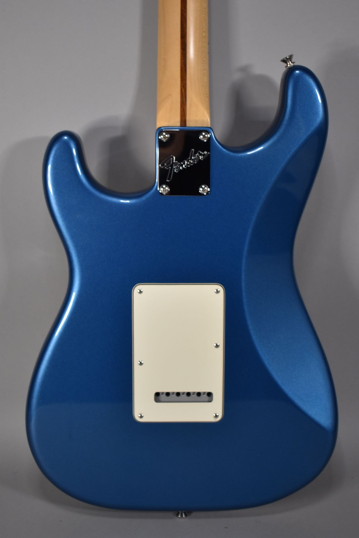 Rear view of a satin Lake Placid Blue Stratocaster body, showing the neck plate, maple neck, and cream tremolo cover.