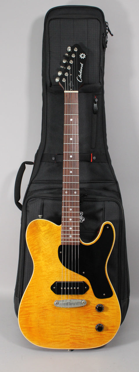 Full-length view of an amber nitro-finished electric guitar with a flamed maple top, black pickguard, P90 pickup, and two black knobs.