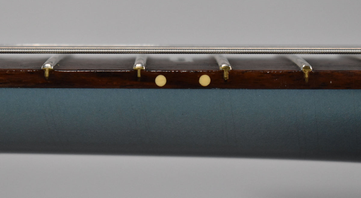 Close-up of the guitar's dark fretboard and metallic Pelham Blue neck, showing two cream-colored side dots and frets.