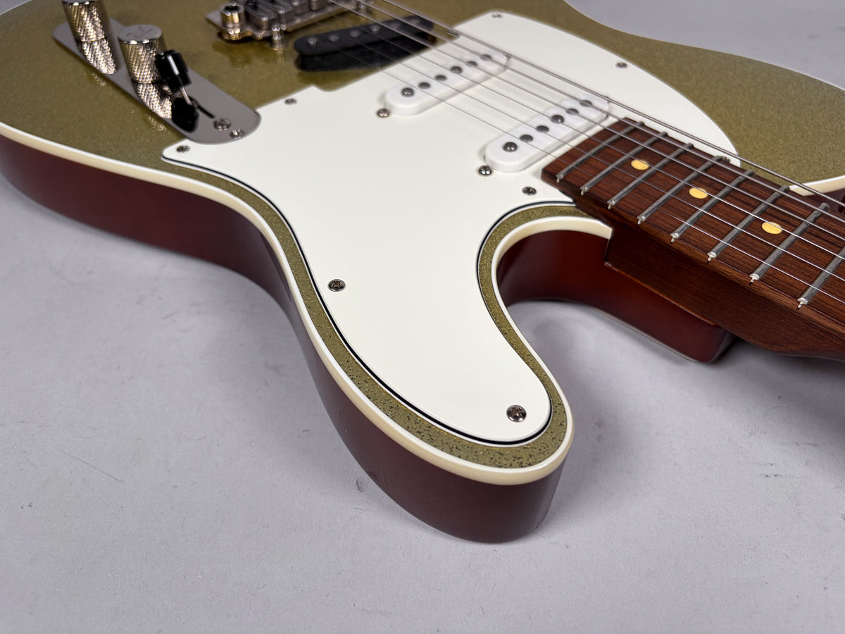 Close-up of the lower bout, showing the gold sparkle top, cream binding, dark red back, white pickguard, and rosewood fretboard.