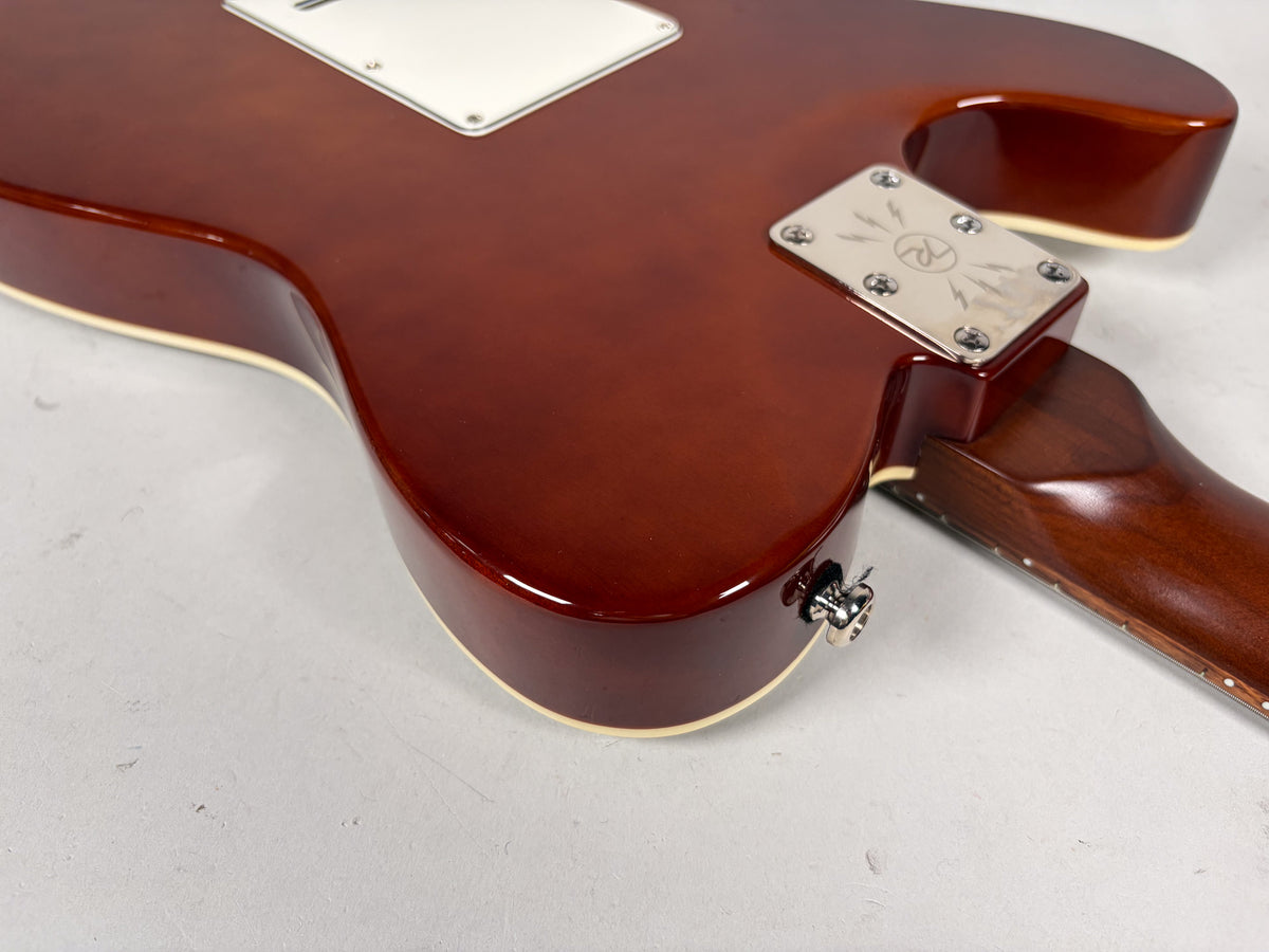 Close-up of the guitar's lower body and neck joint, showing the sparkle brown finish, cream binding, and chrome neck plate.