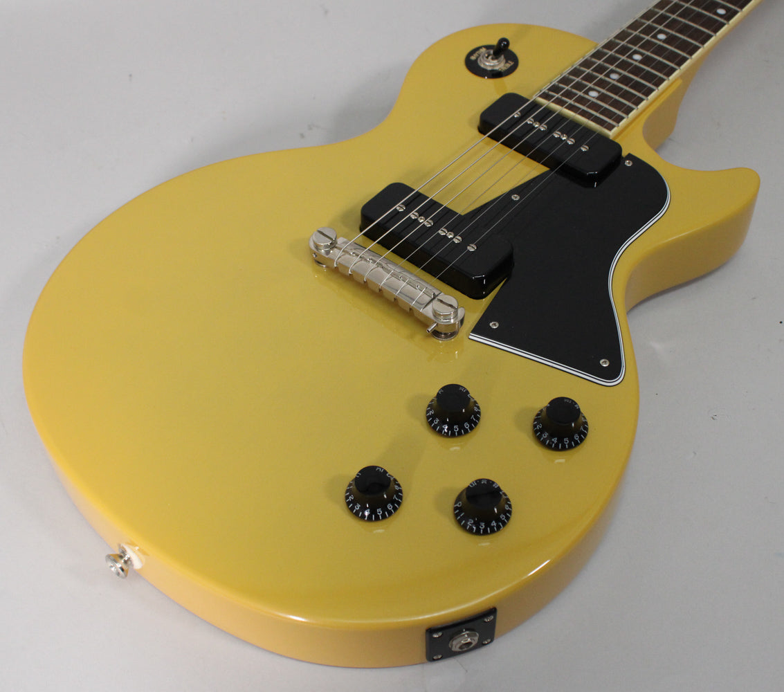 TV Yellow guitar body, angled from above, showing two black P90 pickups, a black pickguard, and four black control knobs.