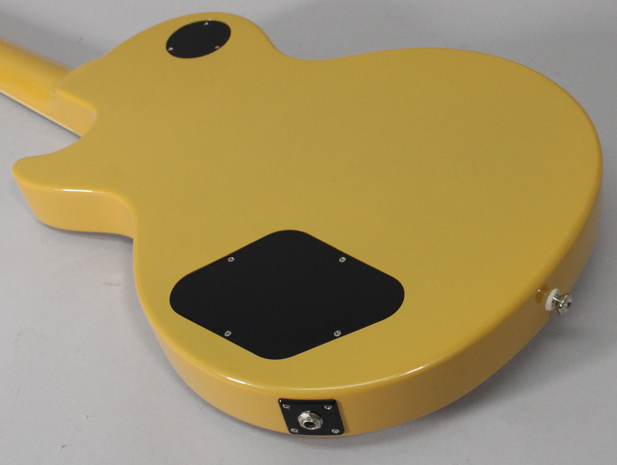 The TV Yellow guitar's back shows a glossy finish, black control cavity cover, and a chrome output jack and strap button.
