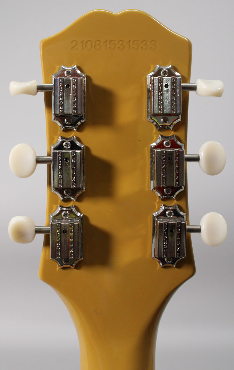 Rear view of the TV Yellow headstock, showing six chrome "Deluxe" tuners with cream buttons and a serial number.
