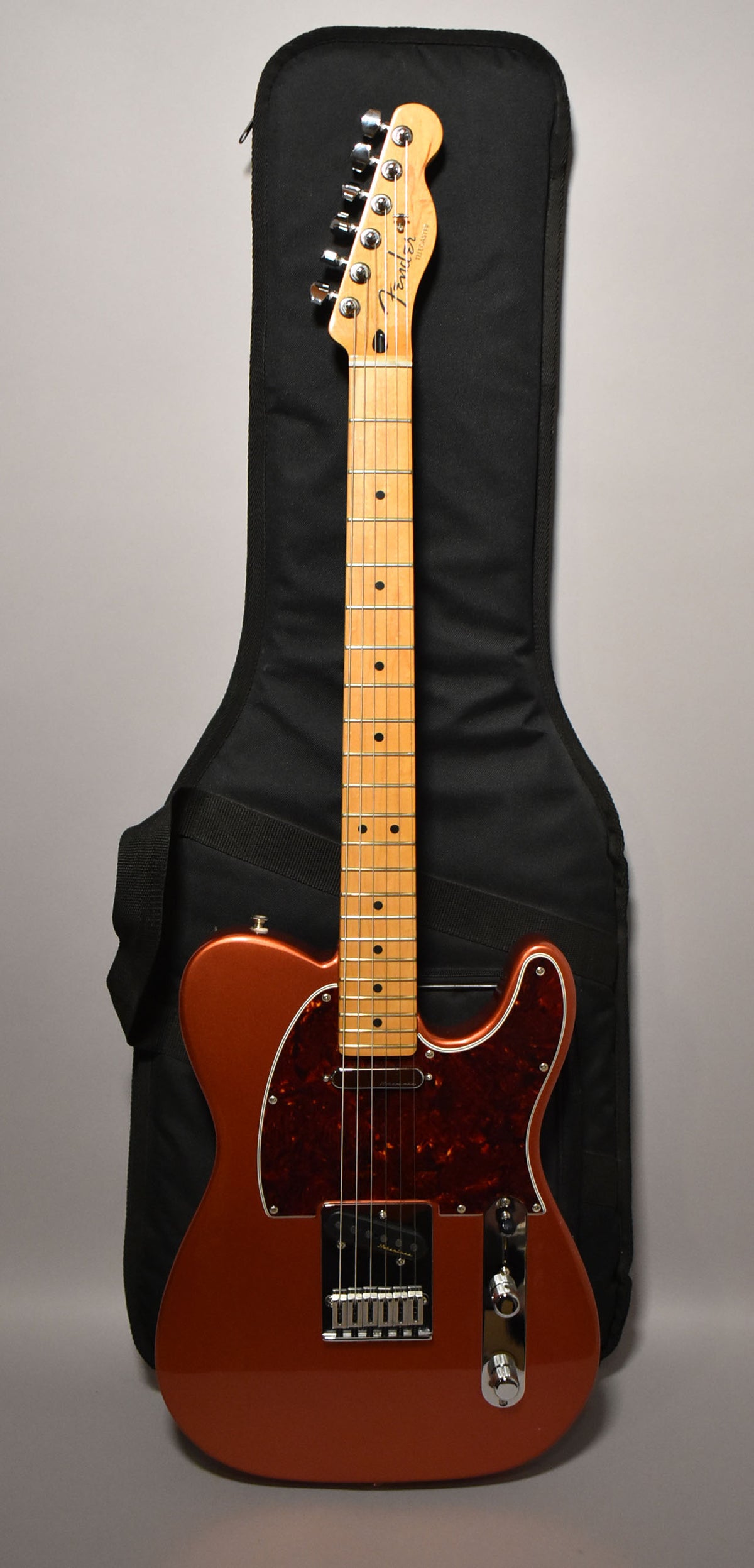 Full view of a metallic candy apple red Telecaster with a maple neck, black dot inlays, and a tortoiseshell pickguard.
