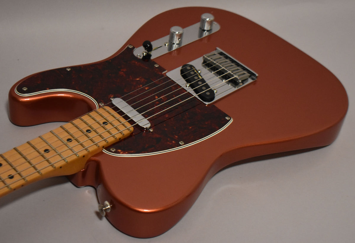 Candy Apple Red Telecaster body, with a tortoiseshell pickguard, chrome hardware, and a maple fretboard, viewed from above.