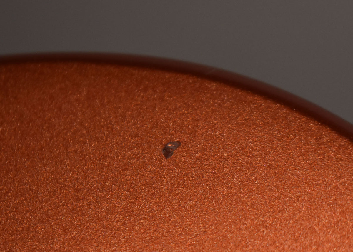 A close-up of the Candy Apple Red finish shows a small, dark chip in the paint near the center of the frame.