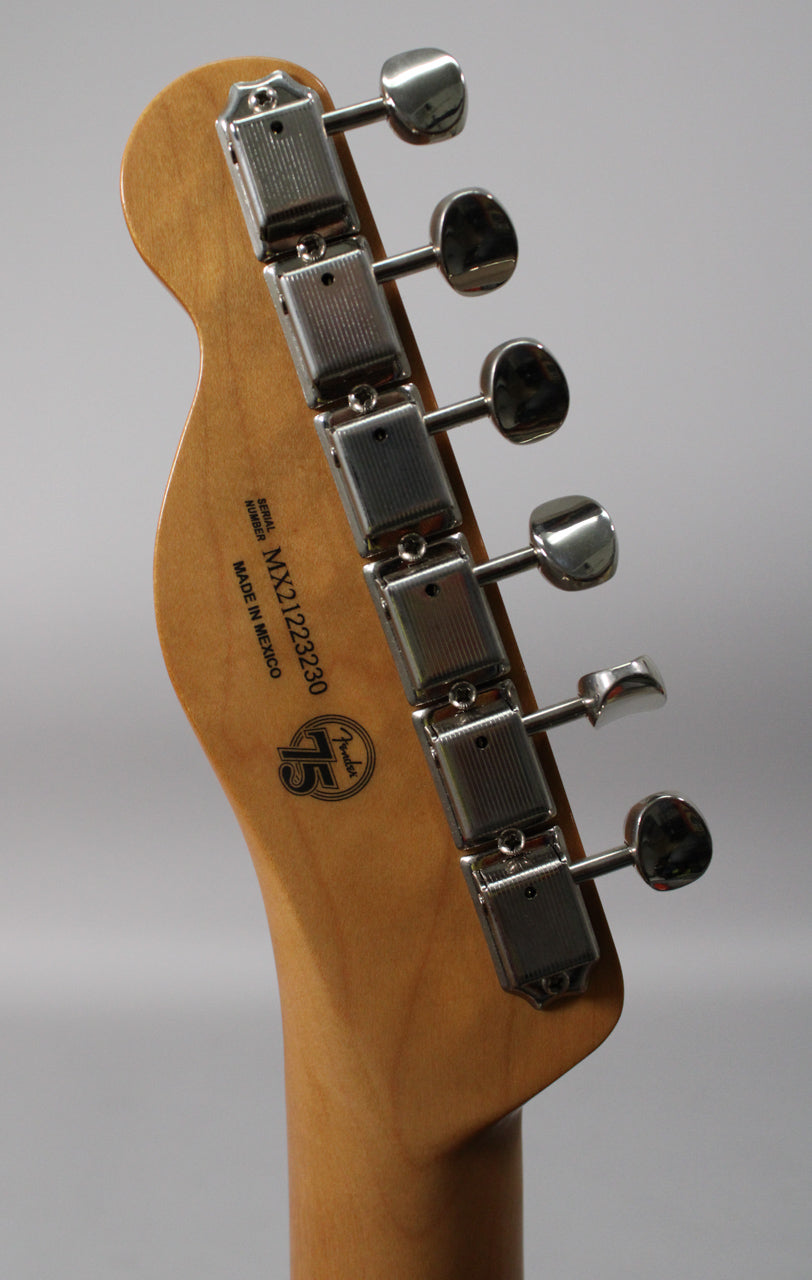 Close-up of the guitar's headstock and neck heel, showing six chrome tuners and a light wood finish.
