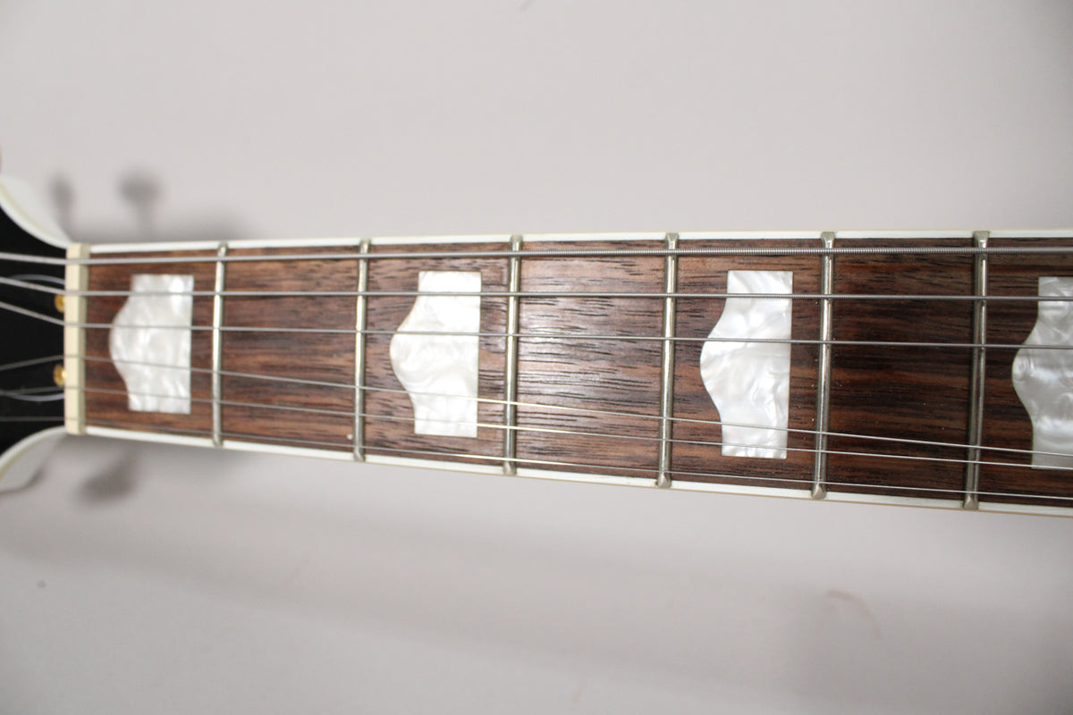 Close-up of the dark wood fretboard with white pearloid Neo-Classic thumbnail inlays and silver frets.