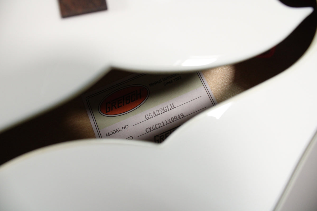 A close-up of the guitar's white hollow body, showing the model label inside the upper f-hole with "G5422GLH" visible.