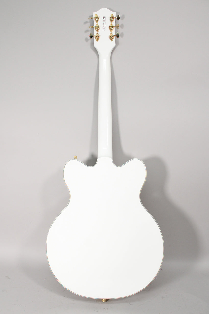 Full rear view of a white double-cut hollow body electric guitar with gold tuners and strap buttons, and a glossy finish.