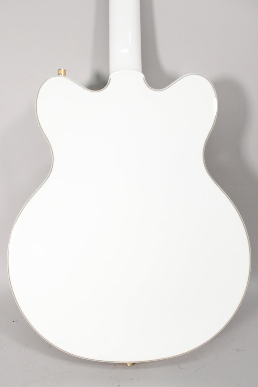 Full back view of a glossy white double-cutaway hollow body electric guitar with gold strap buttons and light binding.