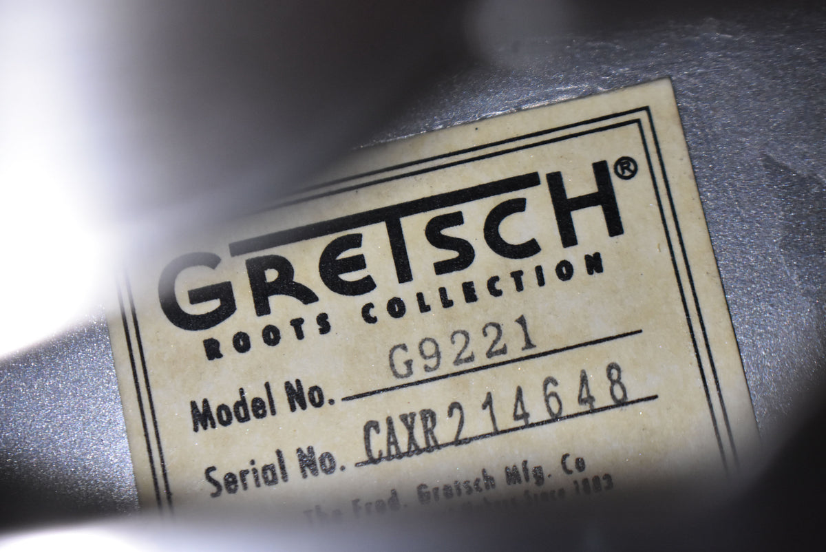 Close-up of the light-colored label inside the resonator, showing the model number G9221 and serial number CAXR214648.