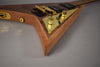 Close-up of the V-shaped body, showing the dark wood top, natural wood sides, and gold hardware on a gold control plate.