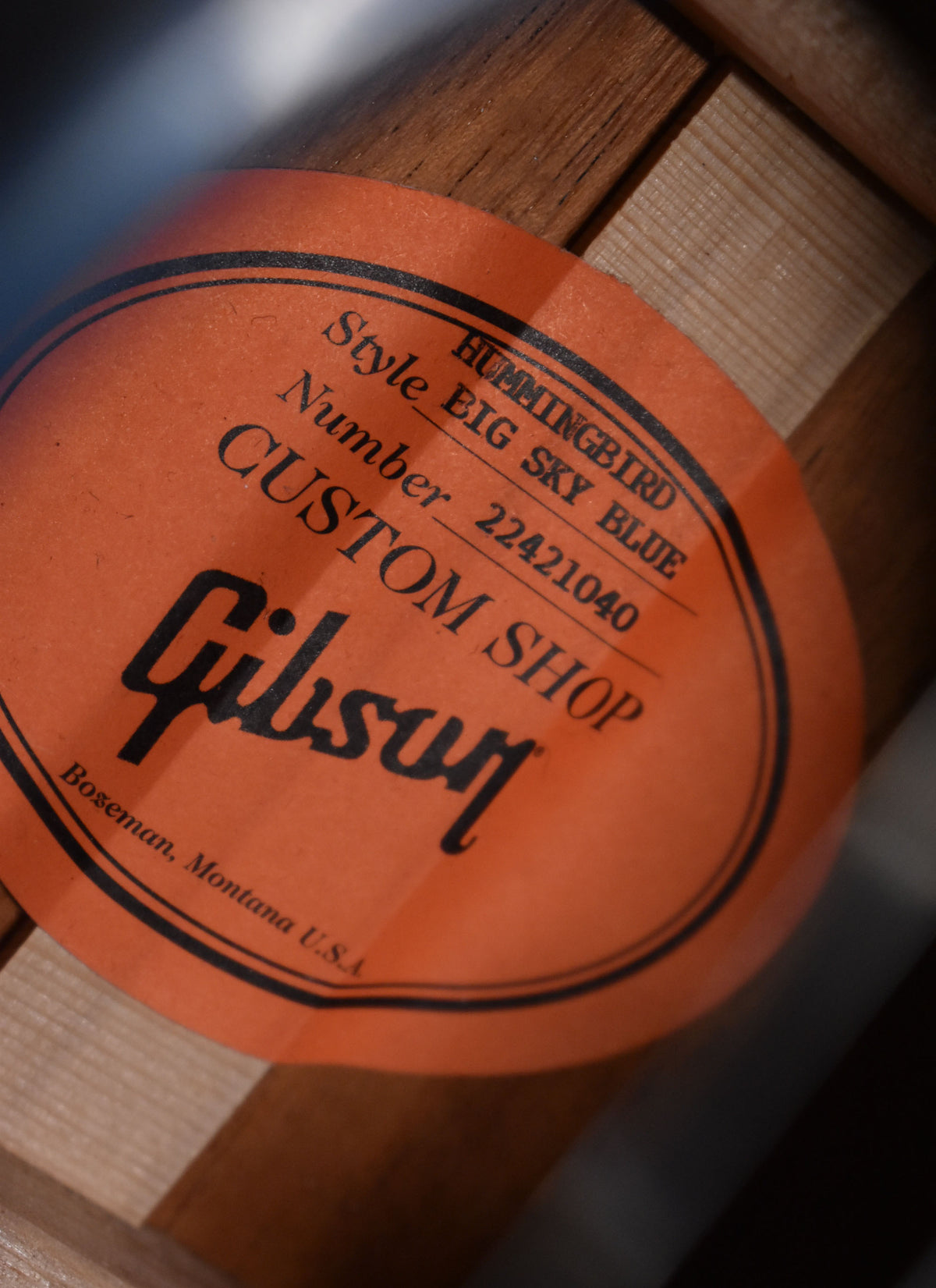 Close-up of the guitar's orange interior label, showing "Hummingbird Style Big Sky Blue" and "Custom Shop" text.