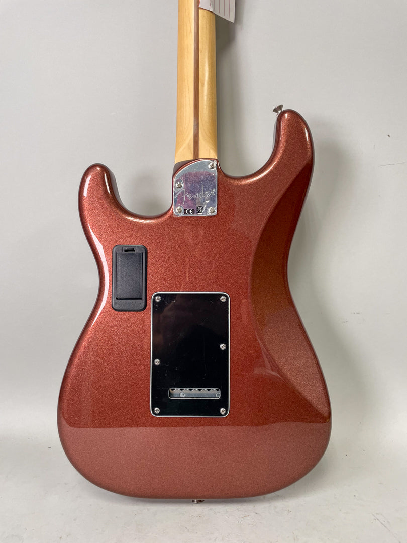 The guitar's back, in metallic copper, shows a black tremolo cover, a black battery compartment, and a chrome neck plate.