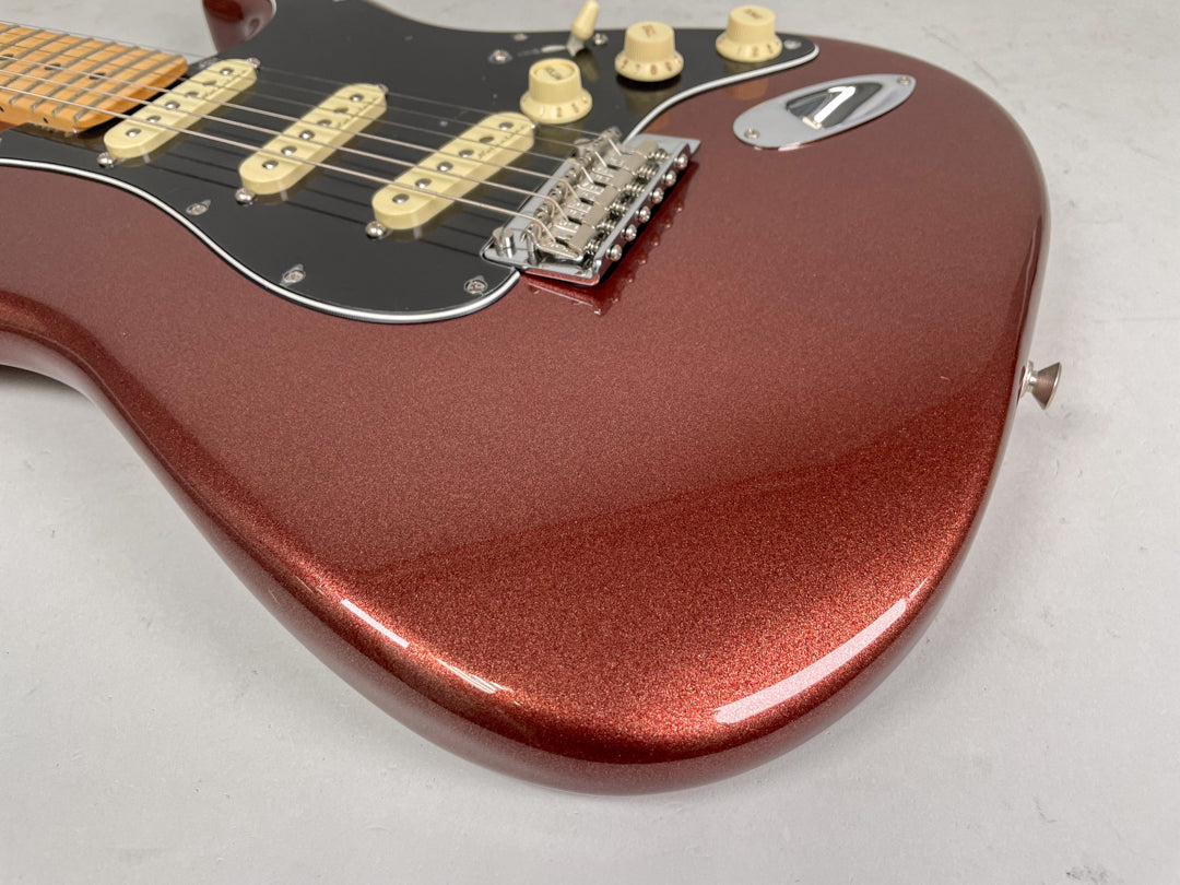 The classic copper Stratocaster body, with a black pickguard, three cream single-coil pickups, and chrome hardware.