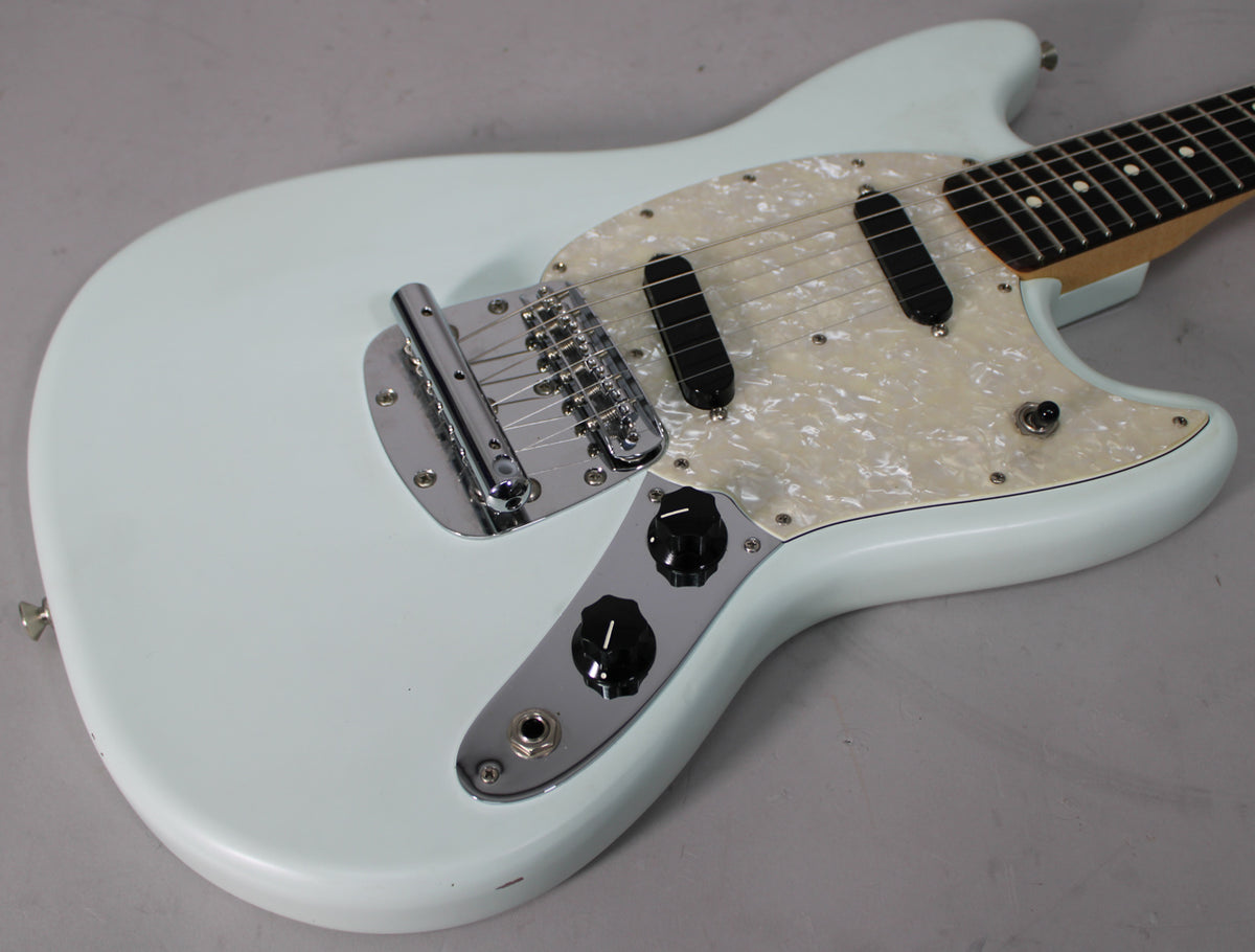 Light blue electric guitar body with a pearloid pickguard, two black single-coil pickups, and chrome hardware, viewed from above.