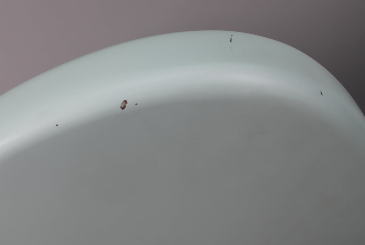 Close-up of the Sonic Blue body's upper curve, showing a few small dark chips and a tiny black mark on the finish.