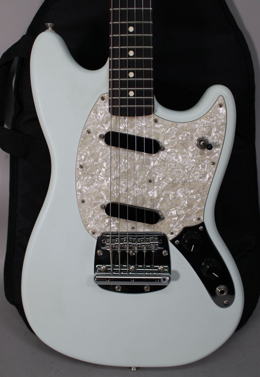 Full-frame view of a light blue electric guitar with a pearloid pickguard, two black single-coil pickups, and chrome hardware.