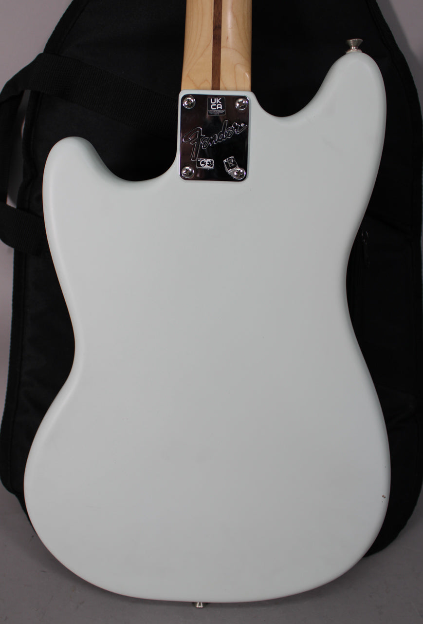 The back of a light blue electric guitar, showing the neck joint with a chrome plate and a strap button on the upper horn.