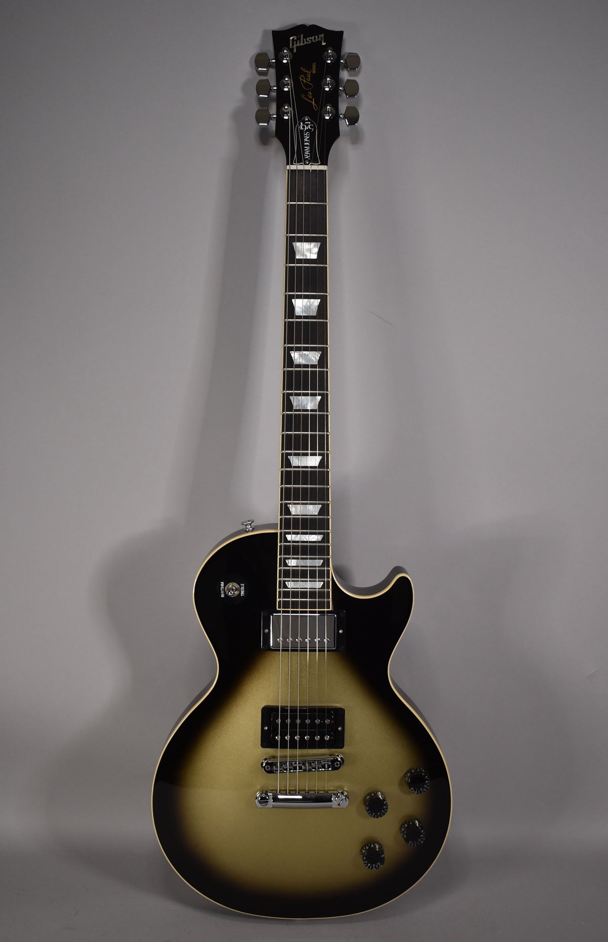 Full-length view of a Les Paul in Antique Silverburst, showing the headstock, neck with trapezoid inlays, and body with chrome hardware.