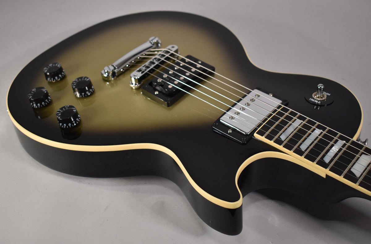 Close-up of the guitar's body, showing the antique silverburst finish, chrome hardware, black control knobs, and cream binding.