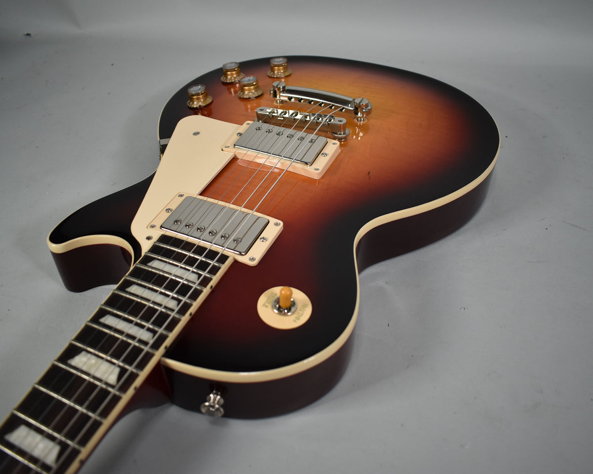 Sunburst electric guitar, angled from the neck, showing the body's glossy finish, cream binding, and chrome hardware.