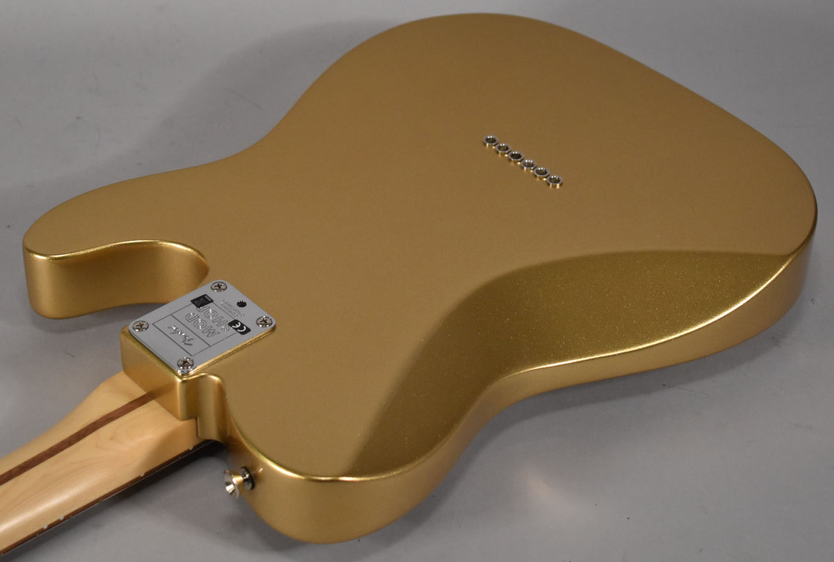The back of a left-handed Telecaster in metallic gold, showing the string-through-body ferrules and a chrome neck plate.