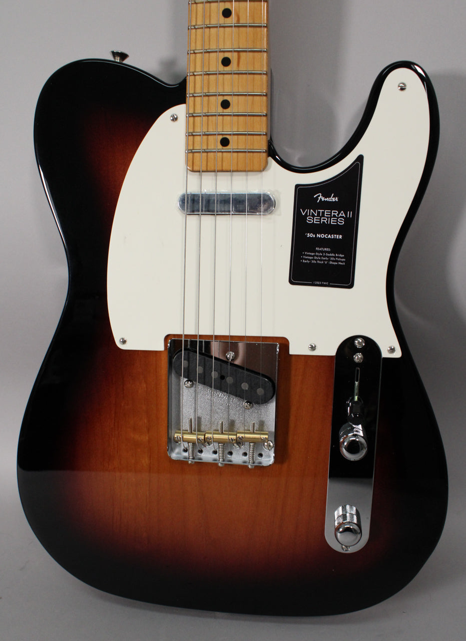 The guitar's two-color sunburst body and white pickguard are shown from the upper bout to the lower controls, with a maple neck.