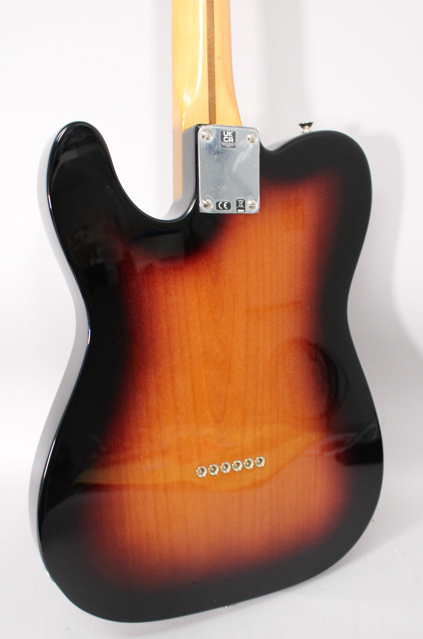 The guitar's glossy 2-color sunburst back shows six string ferrules, a chrome neck plate, and a light maple neck.