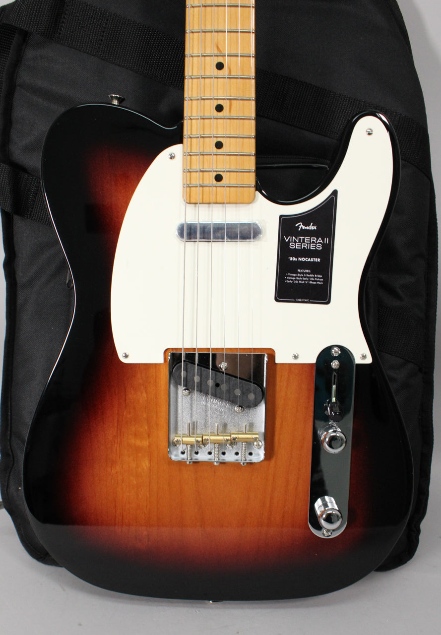 The sunburst electric guitar is angled, showing its body, white pickguard, maple neck, chrome bridge, and control plate.