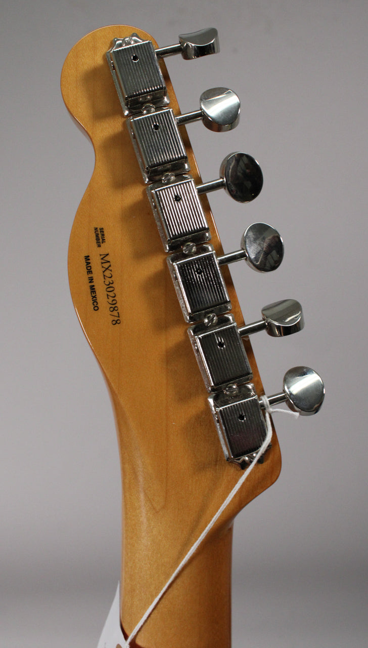 Rear view of the guitar's headstock and neck, showing six chrome tuners with rectangular housings and round buttons.