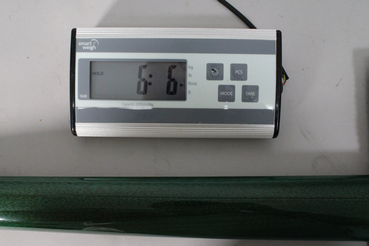 A digital scale displays "6.6" lbs, with a dark teal guitar body visible below it.