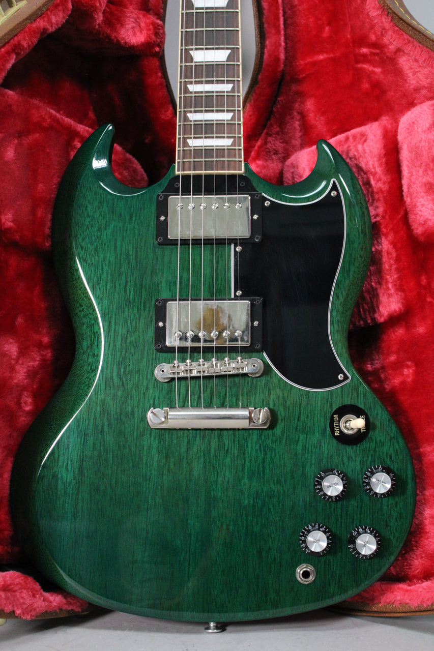 The translucent teal SG Standard is centered, showing its body, neck, and headstock, with a black pickguard and chrome hardware.